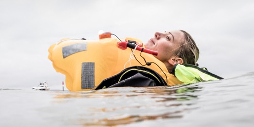 Woman with life jacket floating