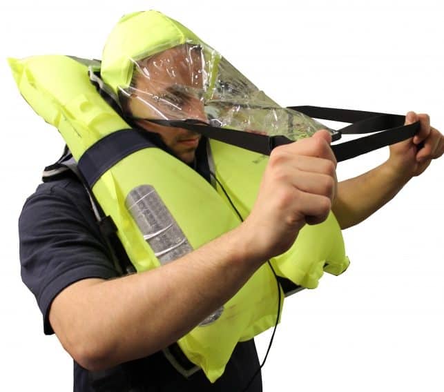 Man wearing a life vest and fitting a spray hood